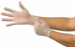 A person puts on a MedPlus Ansell MICRO-TOUCH® ELITE® Powder-Free Synthetic Medical Exam Glove (Small) on their right hand, pulling it over their wrist with their left hand to ensure latex allergy prevention during use.