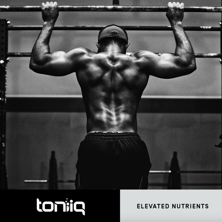 A man lifting weights in a gym while taking Faire.com's Tribulus – 1300mg 95% Steroidal Saponins – 120 Veggie Caps for an elevated nutrient experience.