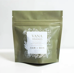 A green bag with white text designed to increase synthesis of collagen for Hair + Skin Fine Plant & Mushroom Powder 2 oz. by Faire.com.