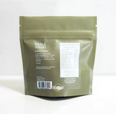 A green bag with white text and a label, designed to increase synthesis of collagen. Hair + Skin | Fine Plant & Mushroom Powder 2 oz. by Faire.com.