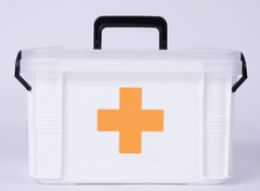 White Faire.com first aid container with orange cross on front.