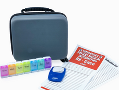 The Faire.com Medication Storage Hard Case in Slate features a seven-day medication organizer, a blue pill cutter, an emergency patient info form, and a medication list—all on a white background—making it perfect for portable pill storage at home or on the go.