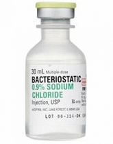 A bottle of Henry Schein Bacteriostatic 0.9% Sodium Chloride Injection, USP (30 mL bottle).