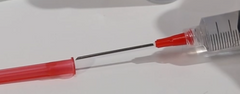 Close-up of a MedNeedles/MedPlus BD 3cc (3ml) 18G x 1 1/2" Luer-Lok Syringe with a Blunt Fill Needle partially inserted into a red protective cap lying on a white surface.