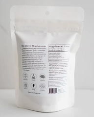 An adaptogenic bag of Reishi Mushroom Powder 2 oz. | 50 servings from Faire.com on a white surface.