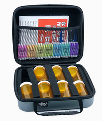 The Faire.com Medication Storage Hard Case in Slate features six empty pill bottles, a weekly medication organizer, and informational pamphlets neatly stored in an interior mesh pocket, providing convenient portable storage for all your needs.