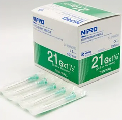 A box of Nipro 3cc (3ml) 21G x 1 1/2" Luer-Lock Syringe & Hypodermic Needle Combo (50 pack) on a table.